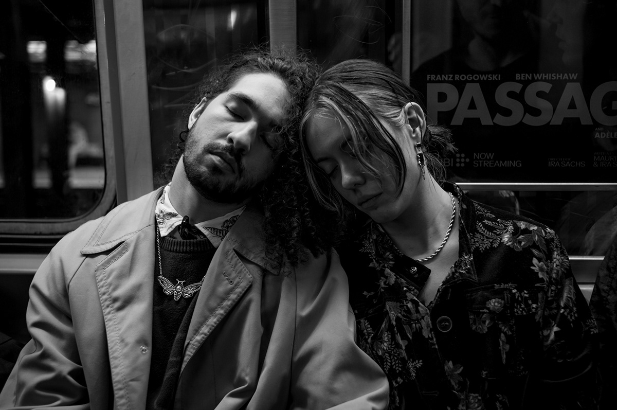 Couple asleep on a New York City subway